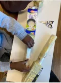 Ein Kind bastelt ein Instrument aus Müll